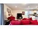 Comfortable living room features red couches and a large TV at 2131 Tripoli Ct, Kissimmee, FL 34747