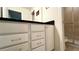 Bathroom with granite countertop, white cabinets, shower, and toilet at 2131 Tripoli Ct, Kissimmee, FL 34747
