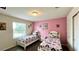 Bedroom with two twin beds and pink accent wall at 2131 Tripoli Ct, Kissimmee, FL 34747