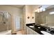 Bathroom with double sinks, granite countertop, and walk-in shower at 2131 Tripoli Ct, Kissimmee, FL 34747