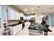 Bright kitchen boasts white cabinets, granite countertops, and stainless steel appliances at 2131 Tripoli Ct, Kissimmee, FL 34747