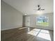 Sunlit living room with hardwood floors and view of the backyard at 16617 Sw 31St Cir, Ocala, FL 34473