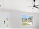 Bright living room featuring a large window, ceiling fan, and hardwood floors at 16617 Sw 31St Cir, Ocala, FL 34473