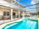 Inviting pool area with covered patio and lush landscaping at 844 Suffolk Pl, Davenport, FL 33896