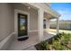 Inviting front porch with white columns and a dark-stained door at 3999 Meandering Bay Dr, Apopka, FL 32712