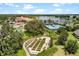 Community overview featuring a clubhouse, lake, tennis courts, and garden at 668 Cordoba Dr, Davenport, FL 33837