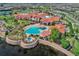 Aerial view showcasing the community clubhouse, pool, and surrounding landscape at 668 Cordoba Dr, Davenport, FL 33837