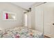 Bright bedroom with floral bedding and double door closet at 668 Cordoba Dr, Davenport, FL 33837
