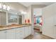 Double vanity bathroom with granite countertops and white cabinets at 668 Cordoba Dr, Davenport, FL 33837
