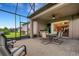 Spacious screened patio with table, chairs, and grill at 668 Cordoba Dr, Davenport, FL 33837