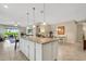 Island kitchen with granite counters and white cabinets at 668 Cordoba Dr, Davenport, FL 33837