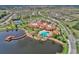 Aerial view of community clubhouse, pool, and surrounding landscape at 668 Cordoba Dr, Davenport, FL 33837