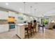 Open kitchen with island, granite counters, and white cabinets at 668 Cordoba Dr, Davenport, FL 33837