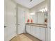 Double vanity bathroom with granite countertops and white cabinets at 668 Cordoba Dr, Davenport, FL 33837
