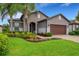 Single-Gathering home with landscaped yard and brick driveway at 668 Cordoba Dr, Davenport, FL 33837