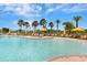 Relaxing community pool with yellow umbrellas and lounge chairs at 668 Cordoba Dr, Davenport, FL 33837