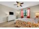 Spacious bedroom with floral bedding, a white dresser, and a ceiling fan at 668 Cordoba Dr, Davenport, FL 33837