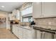 Kitchen features granite countertops, white cabinets, and a pantry at 668 Cordoba Dr, Davenport, FL 33837