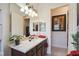 Bathroom with granite vanity, dark wood cabinets, and a large mirror at 806 Ebb Tide Ln, Poinciana, FL 34759