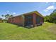 Home's exterior with a screened patio and well-manicured lawn at 806 Ebb Tide Ln, Poinciana, FL 34759