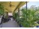 Relaxing screened porch with lush landscaping at 806 Ebb Tide Ln, Poinciana, FL 34759