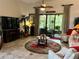 Relaxing living room with a fireplace, large TV, and access to a patio at 806 Ebb Tide Ln, Poinciana, FL 34759