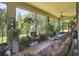 Relaxing sunroom filled with plants and comfortable seating at 806 Ebb Tide Ln, Poinciana, FL 34759