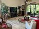 Comfortable living room with a large TV and access to a patio at 806 Ebb Tide Ln, Poinciana, FL 34759
