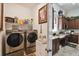 Laundry room with washer, dryer, and kitchen view at 806 Ebb Tide Ln, Poinciana, FL 34759