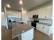 Modern kitchen with white cabinets and granite island at 5306 Maddie Dr, Haines City, FL 33844