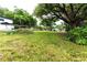 Spacious backyard with lush green grass and large trees at 1419 36Th St, Orlando, FL 32839