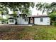 White two-story house with mature trees and landscaping at 1419 36Th St, Orlando, FL 32839