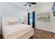 Bright bedroom with a comfortable queen-size bed and wood floors at 3044 Salted Rim Rd, Kissimmee, FL 34747