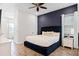Spacious Primary bedroom with plush king-size bed and dark blue decor at 3044 Salted Rim Rd, Kissimmee, FL 34747