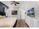 Bright bedroom with king-size bed, white dresser, and large TV at 3044 Salted Rim Rd, Kissimmee, FL 34747