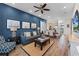 Bright living room with comfy seating, large TV, and wood-look floors at 3044 Salted Rim Rd, Kissimmee, FL 34747