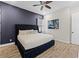 Spacious bedroom with king-size bed, dark-purple accent wall, and wood-look floors at 3044 Salted Rim Rd, Kissimmee, FL 34747