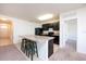 Kitchen with dark cabinets, granite countertops, and an island with three bar stools at 1843 Brockridge Rd, Kissimmee, FL 34744
