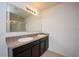 Double vanity bathroom with dark wood cabinets and granite countertop at 1843 Brockridge Rd, Kissimmee, FL 34744