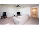 Living room with beige carpet, a sofa, and a ceiling fan at 1843 Brockridge Rd, Kissimmee, FL 34744