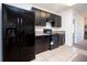 Modern kitchen features dark wood cabinets, granite countertops, and stainless steel appliances at 1843 Brockridge Rd, Kissimmee, FL 34744
