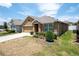 Tan one-story house with a two-car garage and a small front yard at 1843 Brockridge Rd, Kissimmee, FL 34744