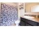 Clean bathroom with a shower/tub combo, vanity with dark cabinets, and a toilet at 1843 Brockridge Rd, Kissimmee, FL 34744
