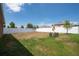 Spacious backyard with a white fence and small patio set at 1843 Brockridge Rd, Kissimmee, FL 34744