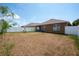 Dry lawn backyard with white vinyl fence at 1843 Brockridge Rd, Kissimmee, FL 34744