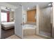 Bathroom with large corner tub, walk-in shower, and bedroom access at 12539 Floridays Resort Dr # 305-D, Orlando, FL 32821