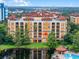 Building exterior view, showcasing its prime location by the lake at 12539 Floridays Resort Dr # 305-D, Orlando, FL 32821