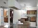 Open concept kitchen and dining area with modern appliances and a glass dining table at 12539 Floridays Resort Dr # 305-D, Orlando, FL 32821