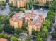 Aerial view of an apartment building with lush landscaping at 12539 Floridays Resort Dr # 305-D, Orlando, FL 32821