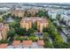 Aerial view of a large apartment building complex with a pool and landscaping at 12539 Floridays Resort Dr # 305-D, Orlando, FL 32821